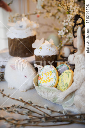 Easter still life with white bunny, decorated cakes and egg cookies 136214708