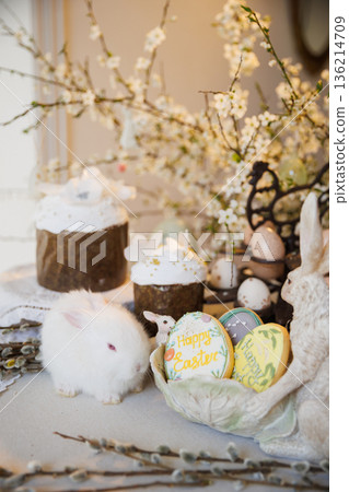 Easter still life with white bunny, decorated cakes and egg cookies 136214709
