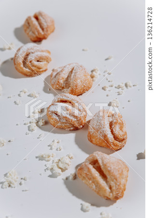 Powdered sugar pastries close-up on white background, soft shadows Powdered sugar pastries close-up on white background, soft shadows 136214728