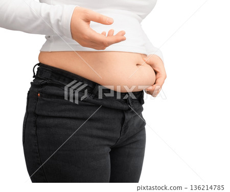 Close-up of overweight woman pinching excess fat on her waist. Female midsection showing belly fat isolated on white background. Concept of weight loss and obesity. High quality photo Close-up of overweight woman pinching excess fat on her waist. Female midsection showing belly fat isolated on white background. Concept of weight loss and obesity. High quality photo 136214785