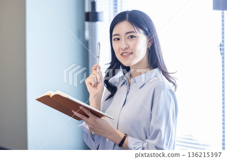 Business woman with a notebook Business woman with a notebook 136215397
