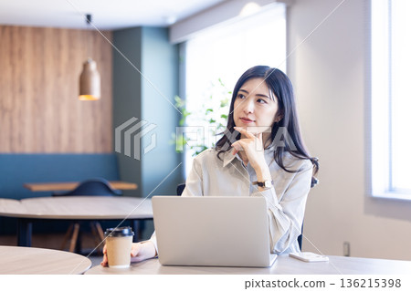 A woman working in a cafe A woman working in a cafe 136215398