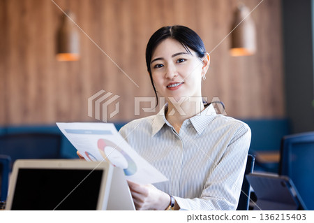 A businesswoman giving a presentation in a conference room A businesswoman giving a presentation in a conference room 136215403