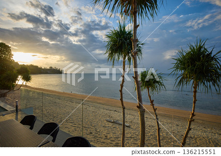 View from luxury villa at sunset, pool lighting, sun loungers for sunbathing, umbrellas from the sun, pillows for swimming in the pool, palm tree on background View from luxury villa at sunset, pool lighting, sun loungers for sunbathing, umbrellas from the sun, pillows for swimming in the pool, palm tree on background 136215551