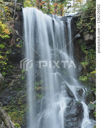 Deep green waterfall in autumn Deep green waterfall in autumn 136216002