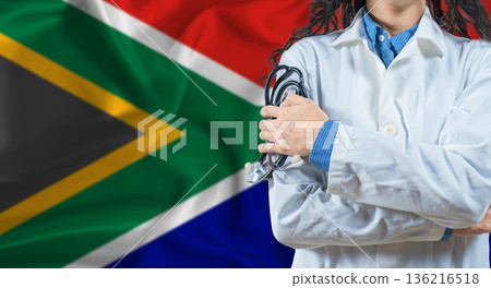Healthcare professional with South Africa flag background. Professional doctor holding stethoscope on South Africa flag background 136216518