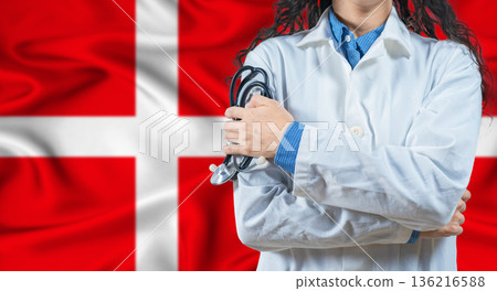 Healthcare professional with Denmark flag background. Professional doctor holding stethoscope on Denmark flag background 136216588