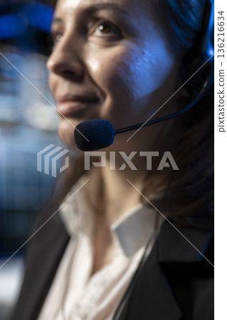 Communication with b2b clients, headset mic closeup and tech support operator in data center. Server hub worker talking in microphone during remote call, troubleshooting errors 136216634