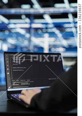 Close up of data center programmer coding on laptop to upgrade datasets processing on infrastructure rigs. Server hub software developer running programming script on notebook to update systems 136216637