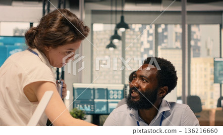 Professional business team collaborating on strategy and development goals. Visual data, charts and reports supporting productivity and performance in a corporate environment. 136216660