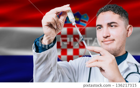 Doctor holding syringe on Croatia flag background. Medical professional holding syringe with Croatian flag in the background Doctor holding syringe on Croatia flag background. Medical professional holding syringe with Croatian flag in the background 136217315