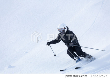 Skiers creating tracks on the fresh snow on the slopes Skiers creating tracks on the fresh snow on the slopes 136217523