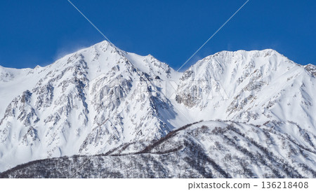 Snowy landscapes and mountain scenery of the Northern Alps shining under a clear blue sky Snowy landscapes and mountain scenery of the Northern Alps shining under a clear blue sky 136218408