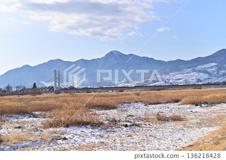 Winter view from the Chikuma River covered with snow and silver grass 136218428