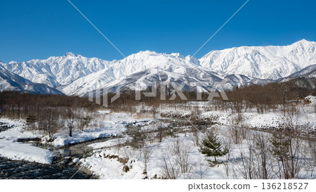 Snowy landscapes and mountain scenery of the Northern Alps shining under a clear blue sky Snowy landscapes and mountain scenery of the Northern Alps shining under a clear blue sky 136218527