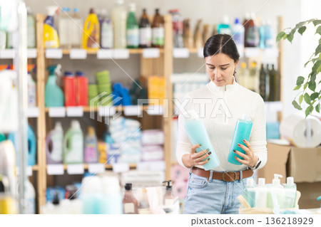 European woman chooses shampoo and shower gel European woman chooses shampoo and shower gel 136218929