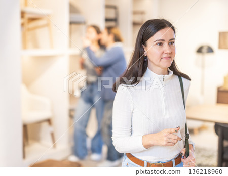 European woman looking at samples in a furniture salon 136218960