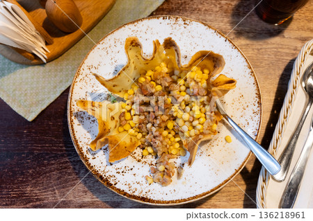 Grey stewed peas with cracklings on a plate 136218961