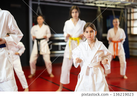 Teenage girl in kimono at karate lesson 136219023