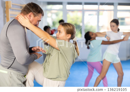 Coach and girl training self-defense techniques Coach and girl training self-defense techniques 136219105