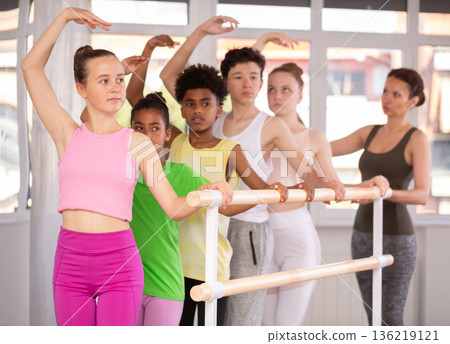 Teenage girl practicing ballet positions in dance studio Teenage girl practicing ballet positions in dance studio 136219121