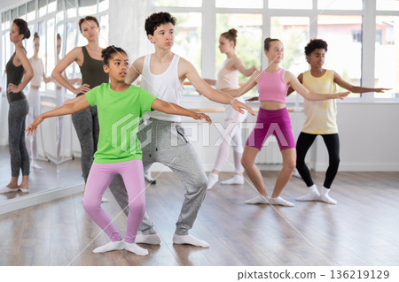 African American preteen girl training in pair with boy in ballet studio African American preteen girl training in pair with boy in ballet studio 136219129