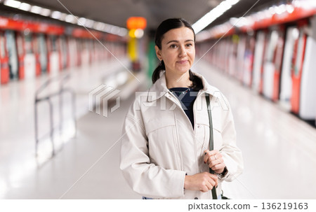 Portrait of woman at metro station waiting for train Portrait of woman at metro station waiting for train 136219163