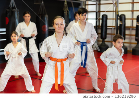 Group of children and teenagers practice karate Group of children and teenagers practice karate 136219290