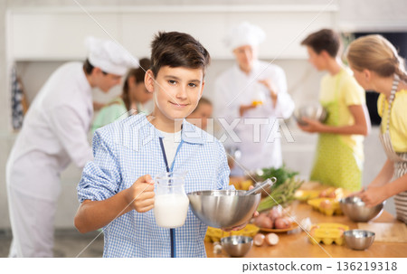 Boy learns how to cook at cooking master class 136219318