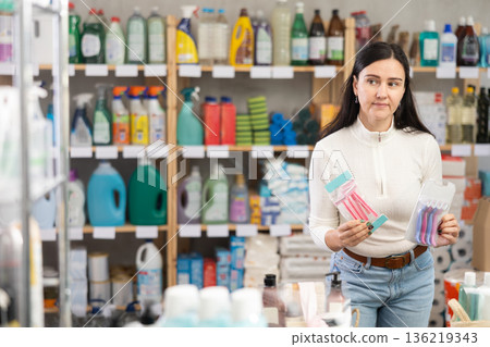 Woman choosing hair shaving machines in supermarket 136219343