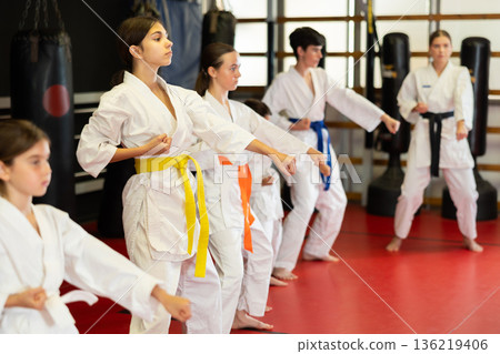 Group of children and teenagers practice karate 136219406