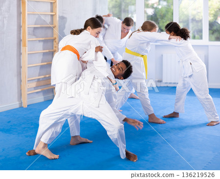 Boy and girl training judo technique 136219526