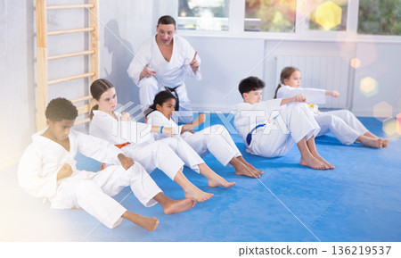 Group of children doing abdominal exercises Group of children doing abdominal exercises 136219537