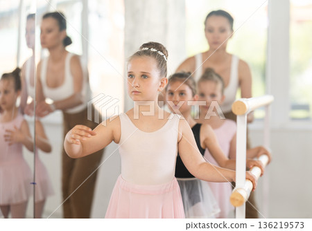 Ballet choreographer teaches little children to get into first position 136219573