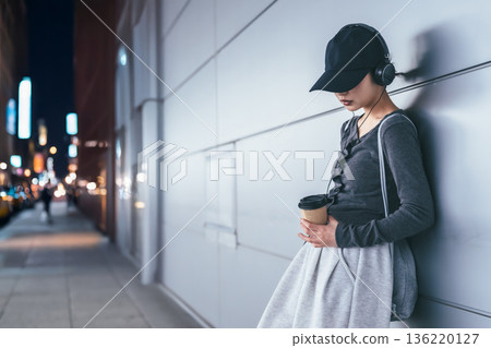 A woman resting in a fantasy city at night A woman resting in a fantasy city at night 136220127
