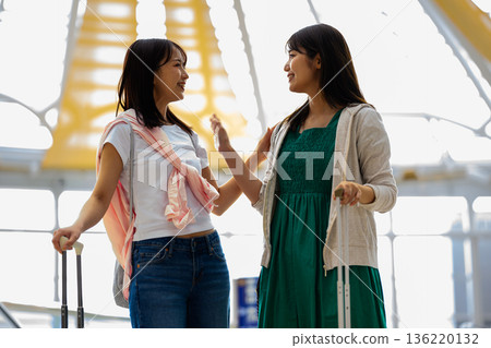 Two women having a conversation at the airport. Photo courtesy of Kansai International Airport (KIX). Two women having a conversation at the airport. Photo courtesy of Kansai International Airport (KIX). 136220132