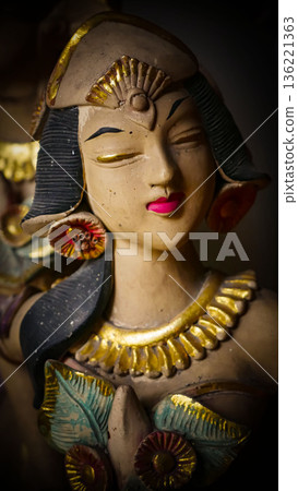 serene Bali dancer ceramic bust featuring closed eyes, bright lips, and gold embellishments. Ideal decorative sculpture for home, temple, or gallery displays, emphasizing art, culture, and craft 136221363
