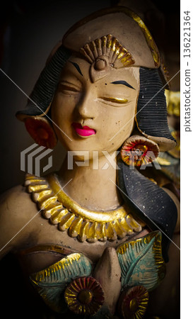 serene Bali dancer ceramic bust featuring closed eyes, bright lips, and gold embellishments. Ideal decorative sculpture for home, temple, or gallery displays, emphasizing art, culture, and craft serene Bali dancer ceramic bust featuring closed eyes, bright lips, and gold embellishments. Ideal decorative sculpture for home, temple, or gallery displays, emphasizing art, culture, and craft 136221364