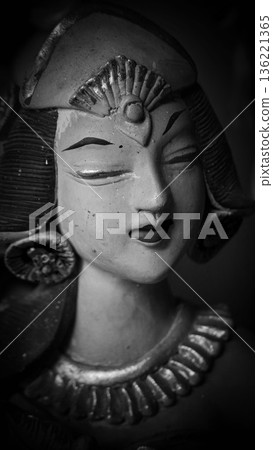 serene Bali dancer ceramic bust featuring closed eyes, bright lips, and gold embellishments. Ideal decorative sculpture for home, temple, or gallery displays, emphasizing art, culture, and craft 136221365