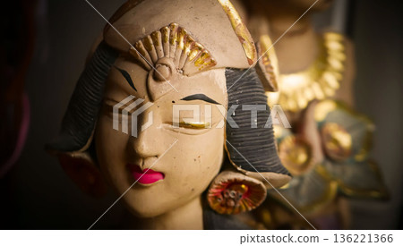 serene Bali dancer ceramic bust featuring closed eyes, bright lips, and gold embellishments. Ideal decorative sculpture for home, temple, or gallery displays, emphasizing art, culture, and craft serene Bali dancer ceramic bust featuring closed eyes, bright lips, and gold embellishments. Ideal decorative sculpture for home, temple, or gallery displays, emphasizing art, culture, and craft 136221366