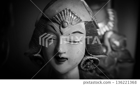 serene Bali dancer ceramic bust featuring closed eyes, bright lips, and gold embellishments. Ideal decorative sculpture for home, temple, or gallery displays, emphasizing art, culture, and craft 136221368