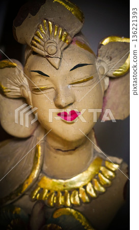 serene Bali dancer ceramic bust featuring closed eyes, bright lips, and gold embellishments. Ideal decorative sculpture for home, temple, or gallery displays, emphasizing art, culture, and craft 136221393