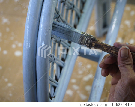 Blue paint hand brush wicker chair furniture renovation closeup home wooden floor craft blue paint hand brush wicker chair 136221419