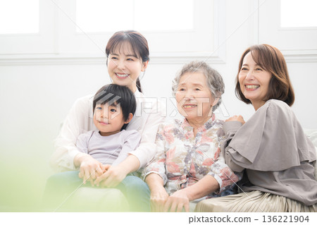 A happy commemorative photo of a four-generation family, with grandmother, mother, and child (great-grandchild) smiling and embracing each other in a beautiful backlit room. A happy commemorative photo of a four-generation family, with grandmother, mother, and child (great-grandchild) smiling and embracing each other in a beautiful backlit room. 136221904