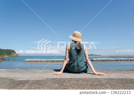 A woman sitting in a breakwater A woman sitting in a breakwater 136222213