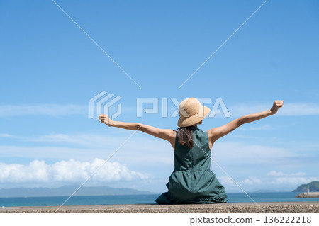 A woman sitting in a breakwater 136222218
