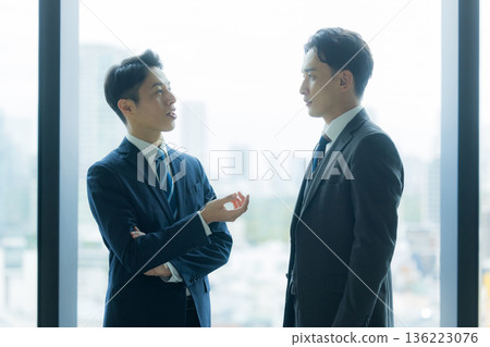 Business people standing and talking Business people standing and talking 136223076