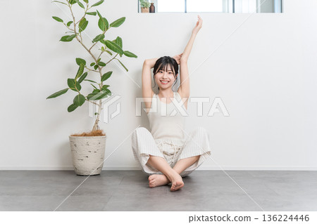 Asian woman stretching and taking deep breaths at home (exercise, fitness) Asian woman stretching and taking deep breaths at home (exercise, fitness) 136224446