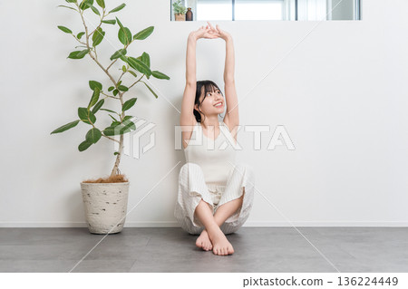 Asian woman stretching and taking deep breaths at home (exercise, fitness) Asian woman stretching and taking deep breaths at home (exercise, fitness) 136224449