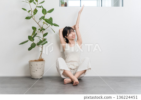 Asian woman stretching and taking deep breaths at home (exercise, fitness) 136224451